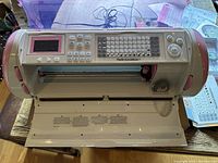 Front view of the Cricut Expression cutting machine showing control panel, screen, and blade compartment.