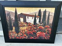 Framed print showing the Tuscan hillside with poppies scene by M. Cellini, in black frame.