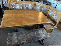 Full view of the German style breakfast nook corner bench with table and separate bench, showing upholstery and wood engraved details
