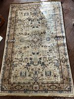 Full view of the vintage rectangular carpet showing overall design and condition.