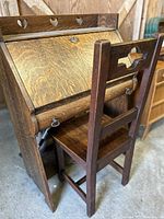 Overall angled view of oak writing desk with matching chair