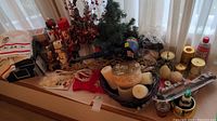 Wide view showing assorted Christmas decorations including nutcrackers, candles, and faux greenery on a windowsill.