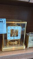 Both clocks side by side on shelf