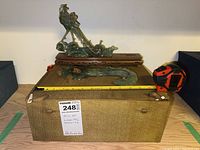 Two jade peacock figurines on top of the carrying case, with one detached piece. Measuring tape showing approximate sizes.