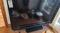 Front view of the Sony Bravia TV showing the 40 inch size label on the upper left corner and the Sony logo at the bottom bezel.