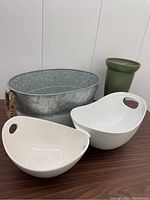 Lot showing all items: two white ceramic bowls, green ceramic vase, and galvanized steel bucket with rope handles on table