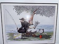 Close-up of the framed cartoon print showing a religious couple fishing with a sign reading Fresh Gefilte Fish and the lake background. Shows the artist signature and edition number 201/300.