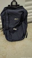 Front view of the dark blue and black North Face backpack with visible logo.