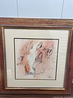 Framed watercolor artwork showing multiple abstract nude human figures in black ink line and orange wash, signed lower right.