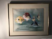 Full view of framed watercolor painting showing five fish underwater with single mat and gold aluminum frame.