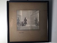 Framed antique bromide photograph showing two girls in sunlight in a corridor setting.