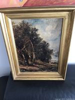 Front view of the antique oil painting in the gold antiqued wood frame showing the forest and shepherd scene