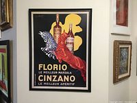Full framed poster on wall showing Florio and Cinzano bottles with zebra and horse figures.