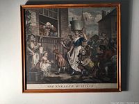 Frontal photo of the complete framed etching showing the entire scene and title 'The Enraged Musician'