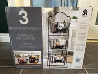 Boxed 3-tier basket stand by Mesa showing three baskets and stand in use