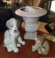 Full view of the Dalmatian pup figurine, the cheetah cub figurine, and the ceramic planter urn on a table indoors