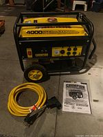 Generator on concrete floor with yellow extension cord coiled and manual laid out