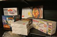 Photo showing the kitchen tools shelf with product boxes including Starfrit fry cutter and blooming onion machine.