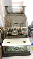 Front view of ornate cast iron cash register
