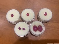 Group shot of all stones in five round containers