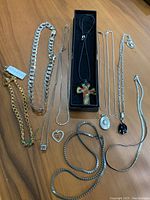 Overall view of 11 necklaces arranged on wood surface