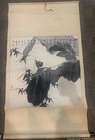 Full view of the Chinese scroll laid flat showing entire artwork and mounting fabric.