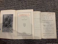 Photo showing the open title pages of both books, revealing titles and authorship.