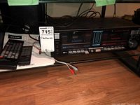 Pioneer CT-W508R stereo dual cassette deck with remote control and RCA cords on a shelf