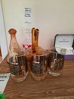 Full view of the glassware set including glasses, decanters, and pitcher with a price tag