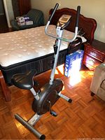 Photo of the Weslo Pursuit CT 2.4 exercise bike showing the entire unit with seat and handlebars in a bedroom setting.