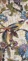 Close-up photo of the colorful bird and floral design on the plate showing cracked glaze.