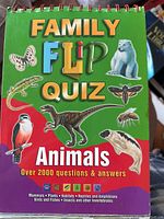 Cover of a spiral-bound quiz book titled 'Family Flip Quiz Animals' showcasing various animal illustrations.