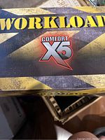 Box lid showing Workload Comfort X5 branding for the shoes.