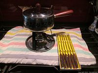 Full setup showing fondue pot on stand with burner and fondue forks in their original box