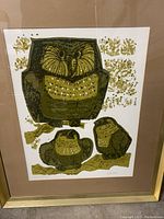 Front view of serigraph artwork "Owl Family" showing mother owl and two babies in green shades, beige matte, brushed brass frame.