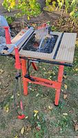 Full view of Hirsh foldable saw table with red metal frame and integrated circular saw blade
