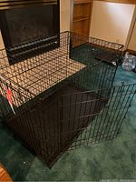 Full view of the large folding metal dog crate with door open, showing plastic tray inside.