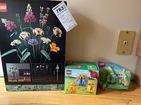 Photo showing LEGO Flower Bouquet box, LEGO Easter Chicks box, and LEGO Easter Bunny bag.