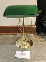 Front view of green glass shade with brass base and pull chain, showing clean finish and good condition