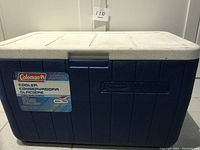 Front view of one blue and white Coleman cooler with the Coleman label visible