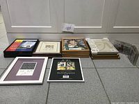 Multiple stacks of picture frames in various colors and styles, some with packaging and labels, mostly 8x10 size.