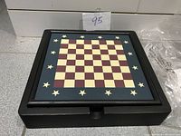Closed wooden game box with Chess/Checkers board on lid decorated with stars