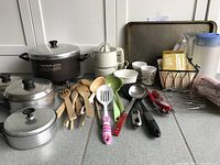 Full lot overview with cooking pots, utensils, juicer, cups, and other kitchen items visible.