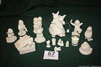 Full lot view showing 10 Snowbabies and 5 miniature solid metal figurines including the ring box and turtle rider