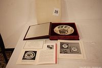 Full lot showing collector plate in red velvet-lined box with original packaging and multiple booklets and certificates included