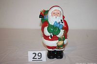 Front view of the cast iron Santa Claus bank showing detailed painted figure and coin slot.