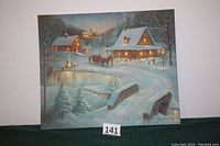 Christmas Eve print with lights off, showing detailed winter landscape with houses, bridge and sleigh