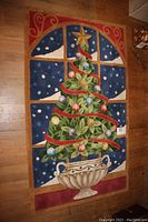 Full view of rectangular Christmas-themed rug showing decorated Christmas tree in decorative urn, window with snowy night scene, and red bordering with swirling patterns.