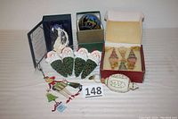 Wide shot showing the variety of Christmas ornaments and figurines, with boxes and loose ornaments grouped.