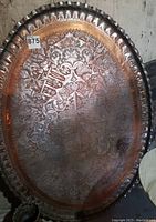 Full top view of the oval copper tray showing overall engraving and shape